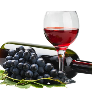 glass of red wine with bottle and grape